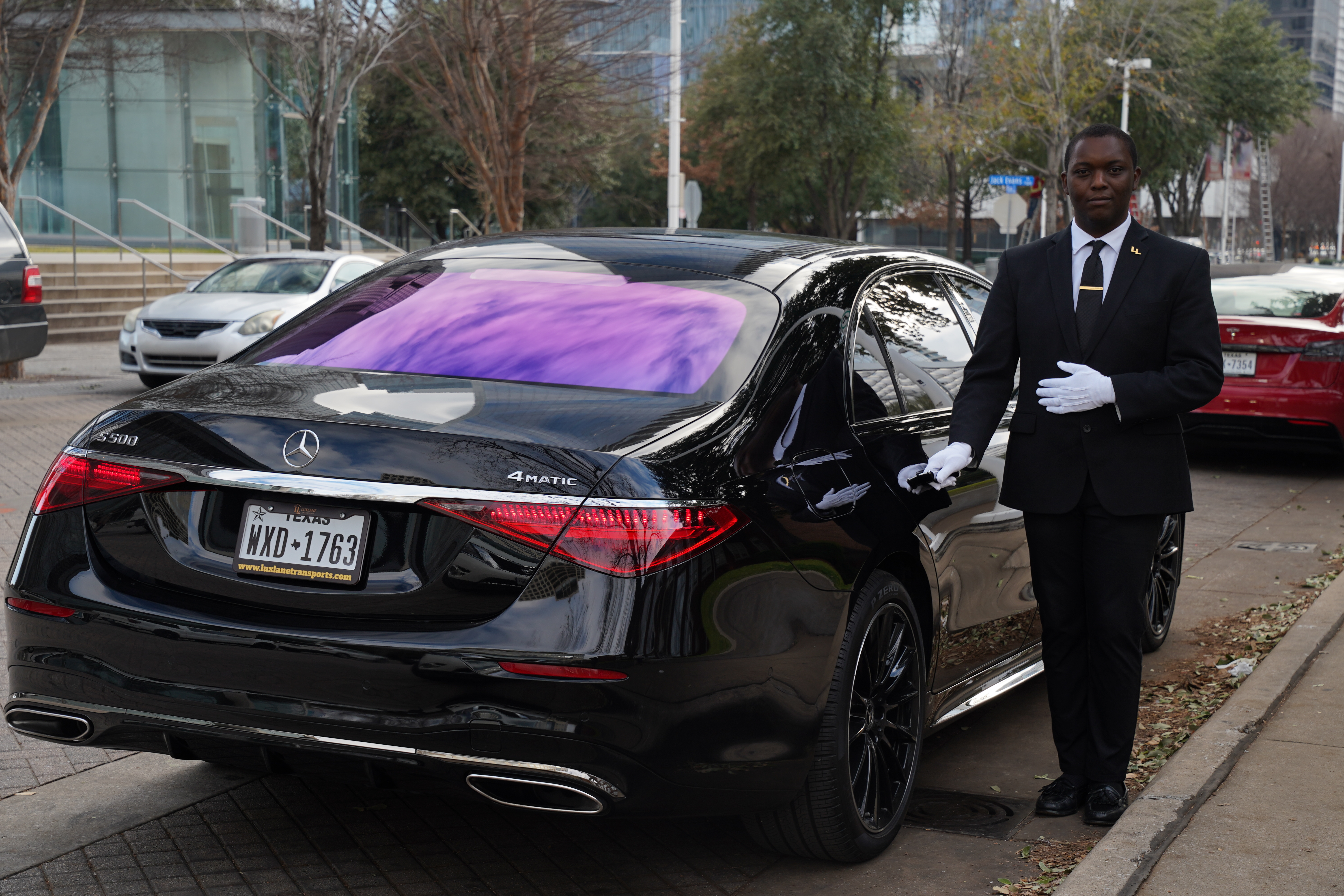 Passengers walking through Dallas Fort Worth International Airport terminal in evening hours