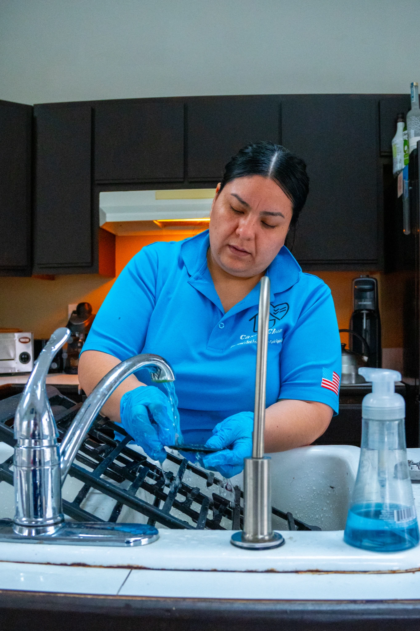 Casita Clean team member wiping down a microwave interior during a deep clean in a suburban kitchen