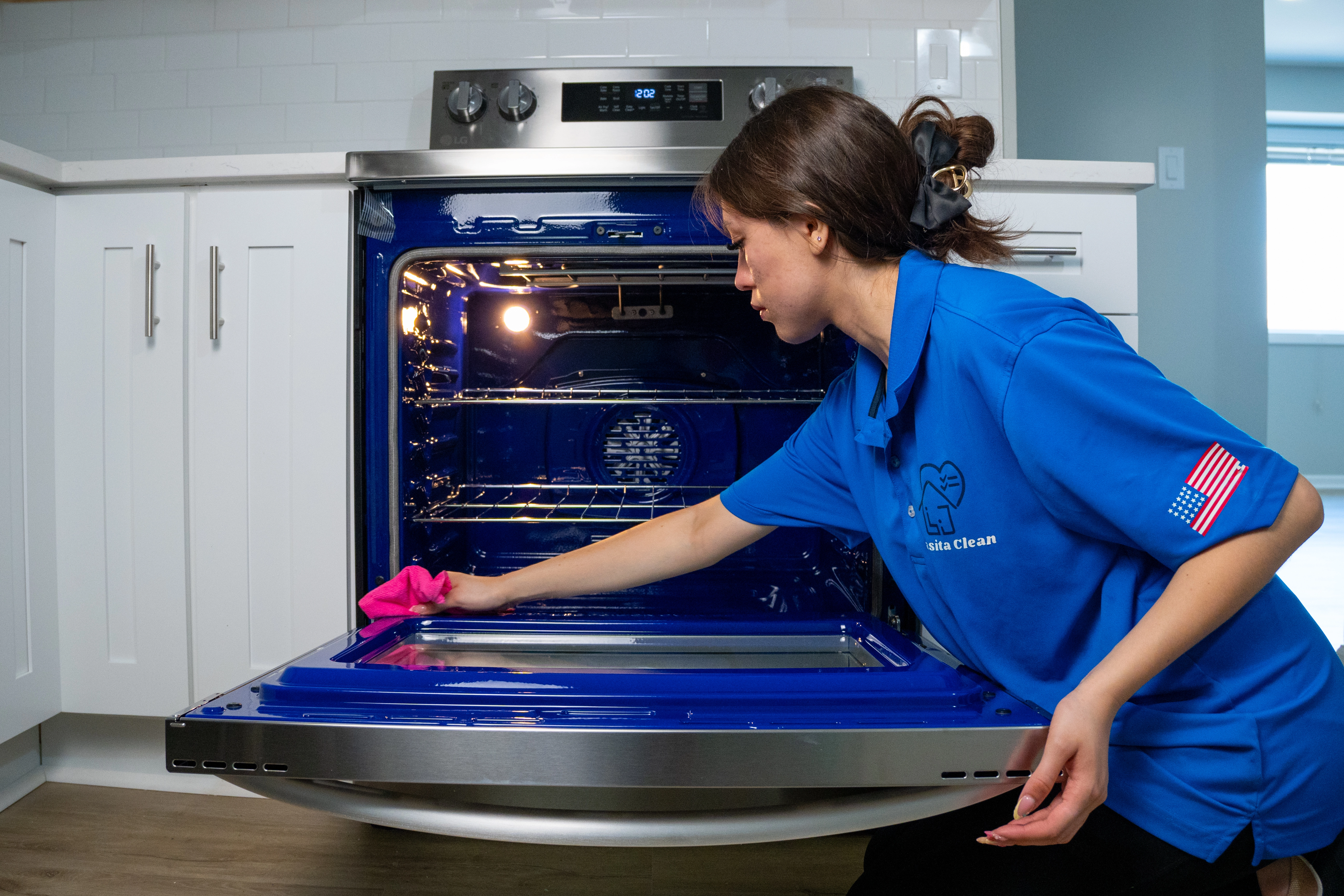 Casita Clean technician deep cleaning the inside of an oven during a move-out service in the Chicago suburbs