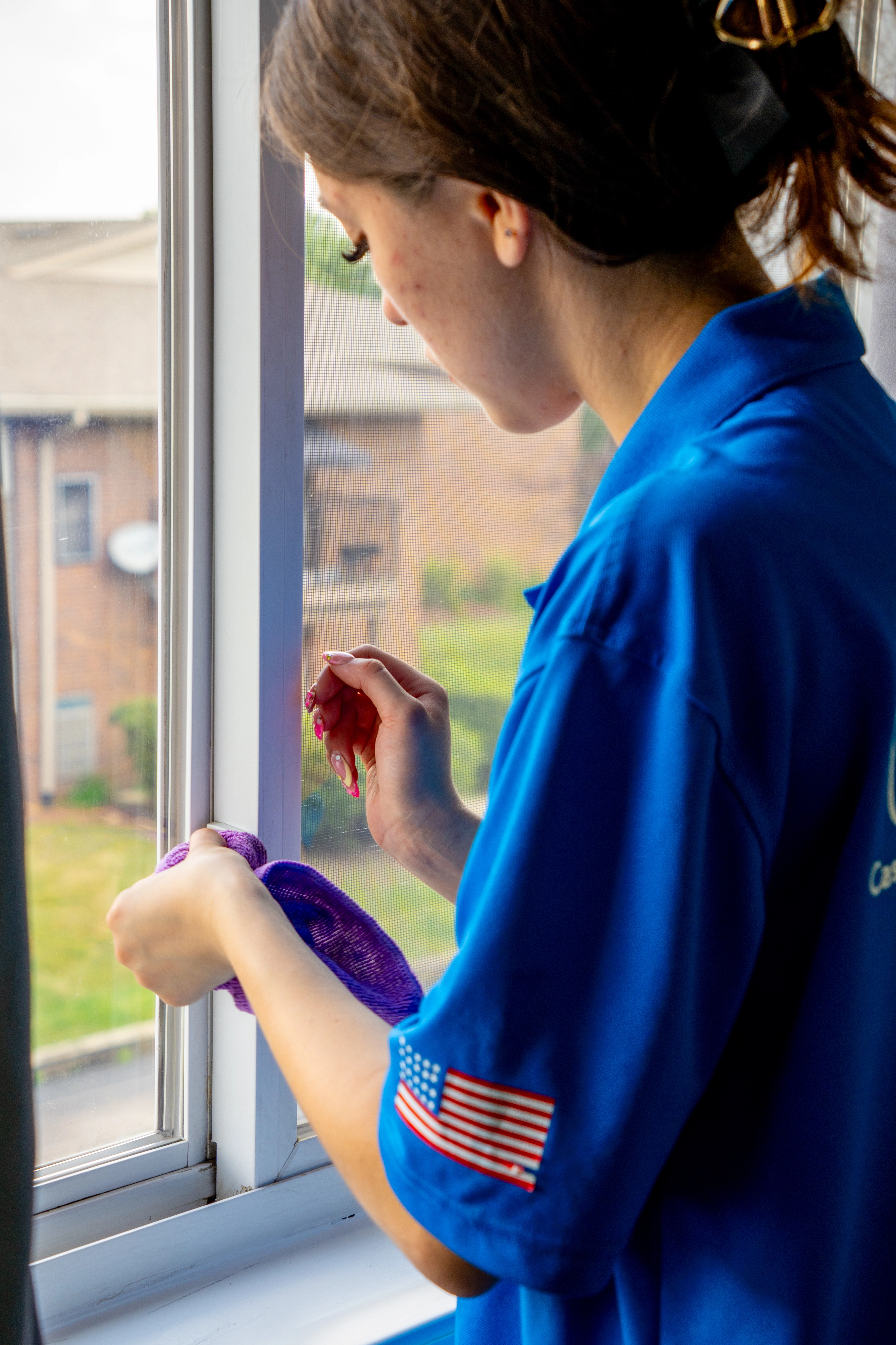 Casita Clean professional wiping down a window sill during a deep clean in Shorewood, IL