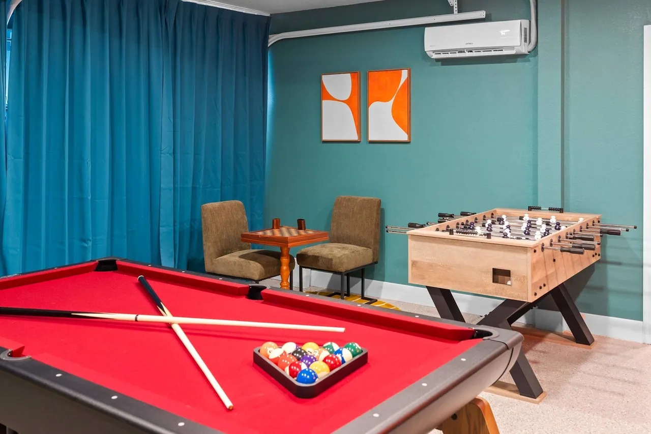 Finished game room with a pool table and foosball table, built by Logan Construction