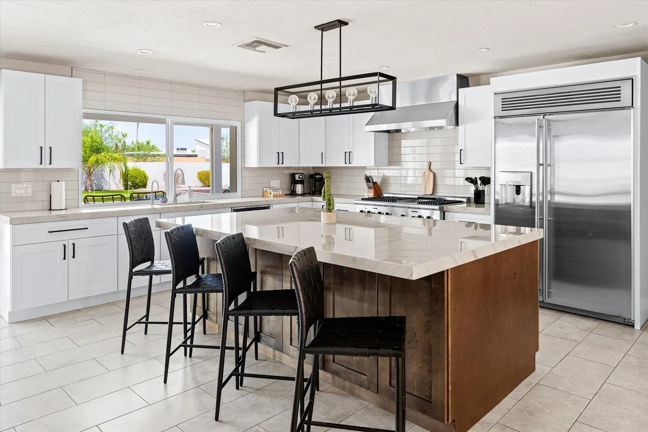Vacation rental kitchen with a large island seating six, remodeled by Logan Construction