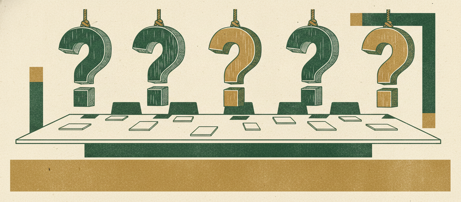 A row of carved question marks over a boardroom table representing due diligence.