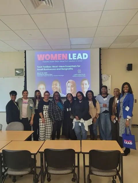 Melanie Oates with women after a technology presentation