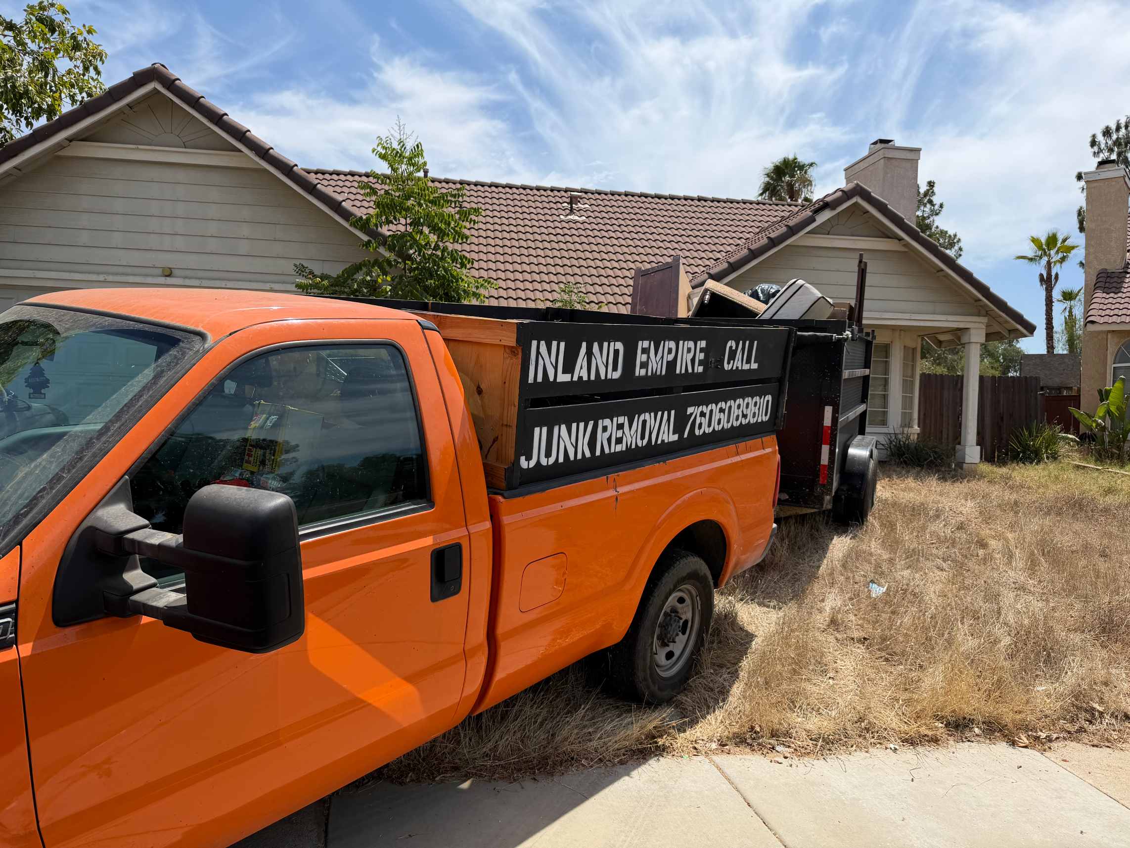 Inland Empire Junk Removal truck loaded on a job site in Riverside