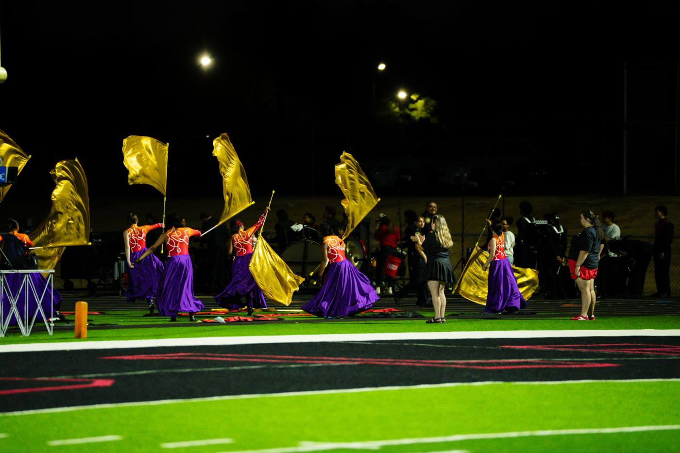 Color guard spinning gold silks during the show