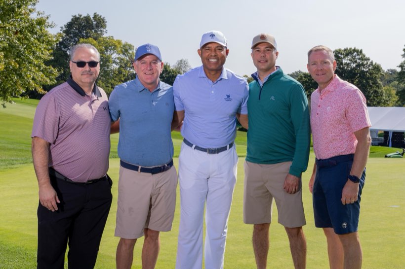 A group of golfers with Mariano Rivera