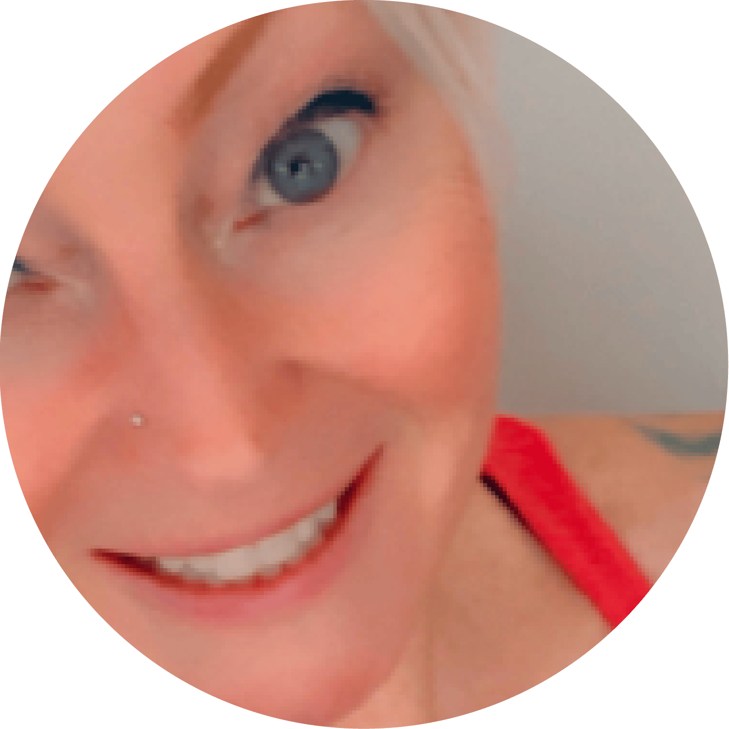 Circular portrait of a smiling woman with blonde hair, a nose stud, and a red tank top.