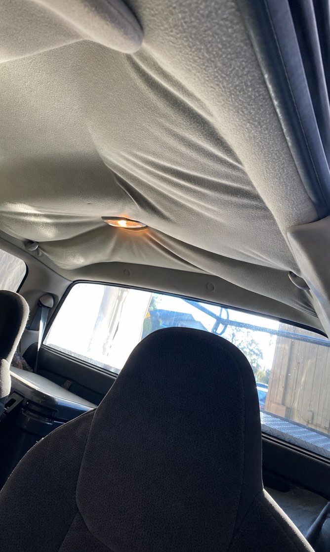 Stained, damaged headliner before repair, example 2