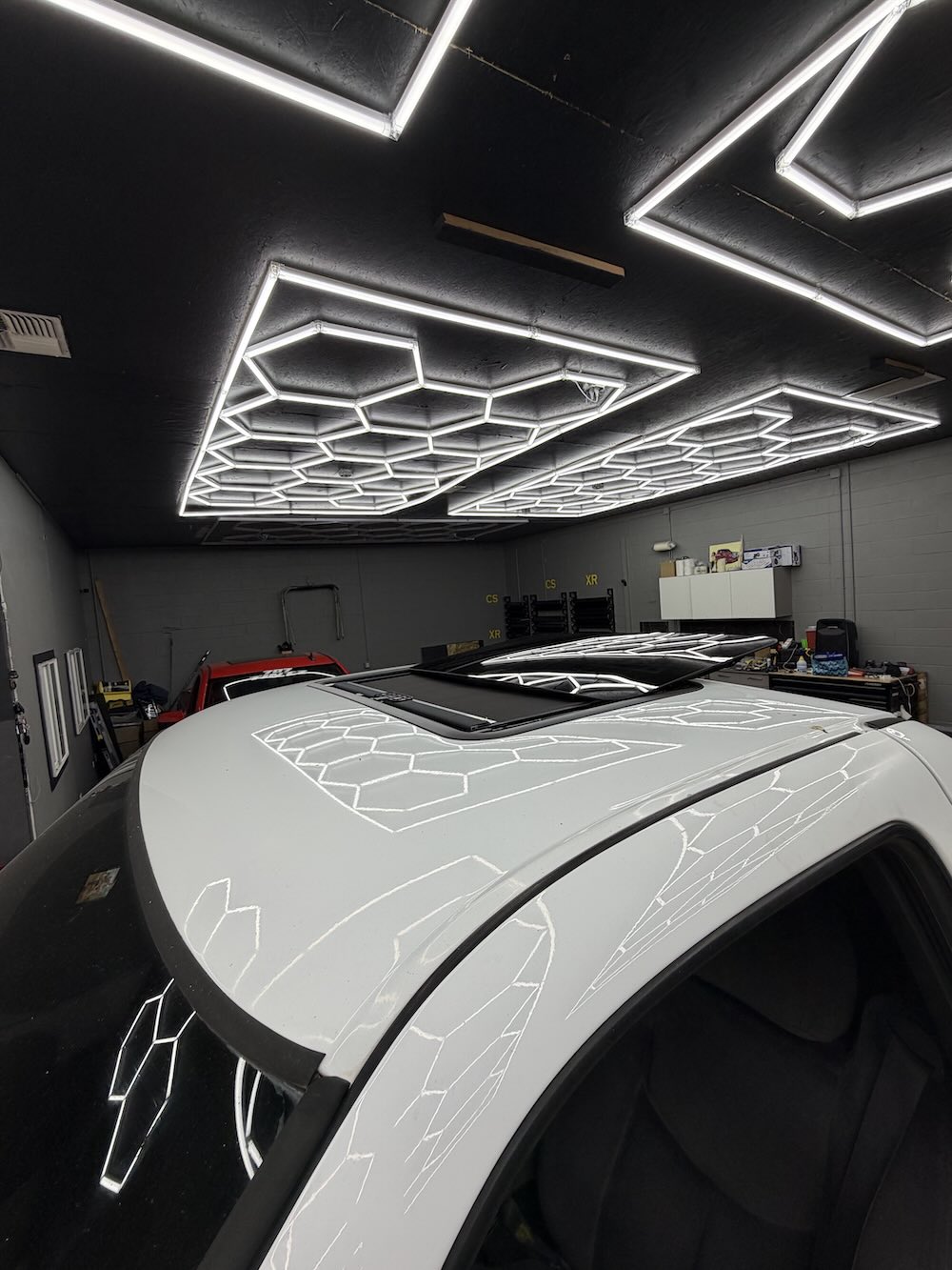 Sunroof wind deflector installed on vehicle roofline, view 1