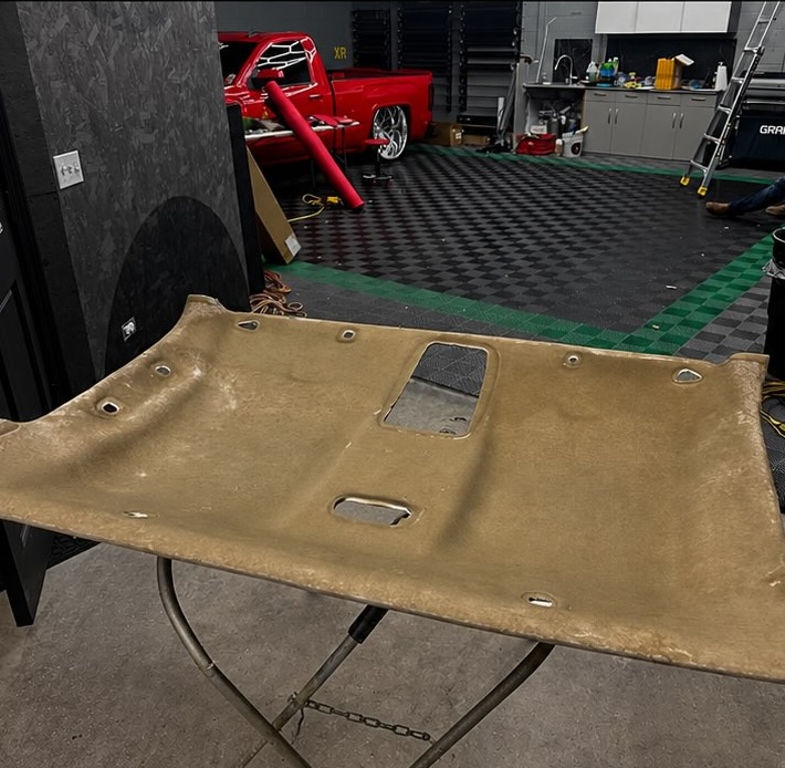 Headliner install in progress, fabric being fitted