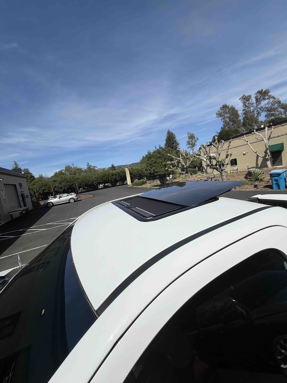 Sunroof wind deflector installed on vehicle roofline, view 3