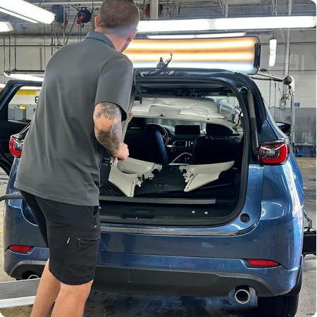 Paintless Dent Repair Technician Restoring Vehicle Panel