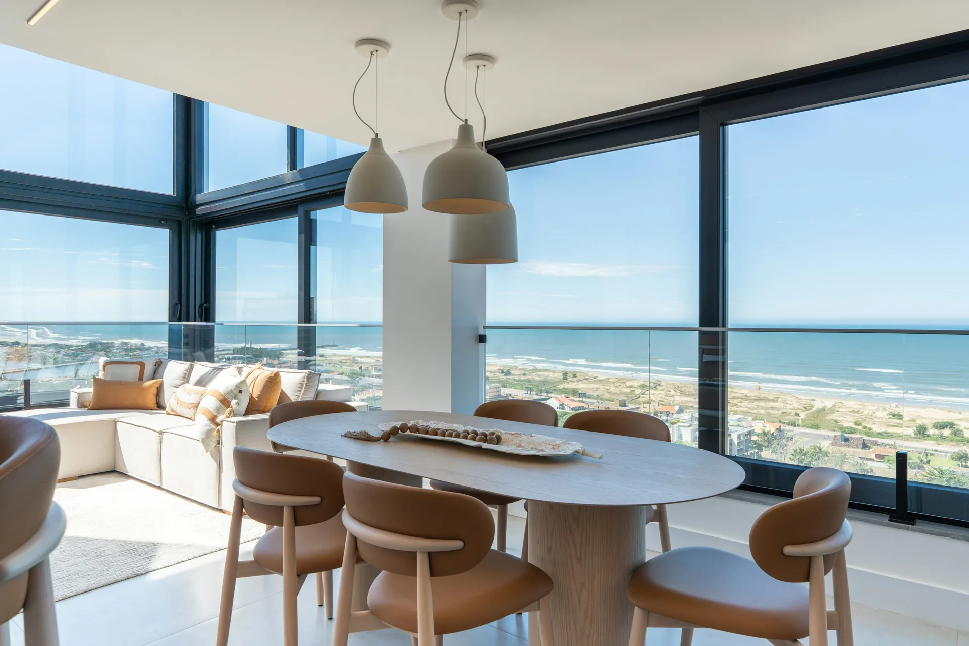 Bright oceanfront dining room with floor-to-ceiling windows, furnished and installed for a South Florida residence
