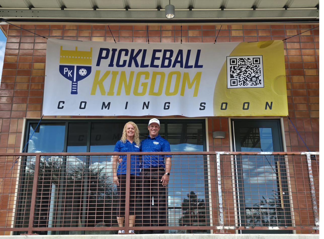 Jared and Pam, owners of Pickleball Kingdom Pflugerville, on the day the Coming Soon banner went up