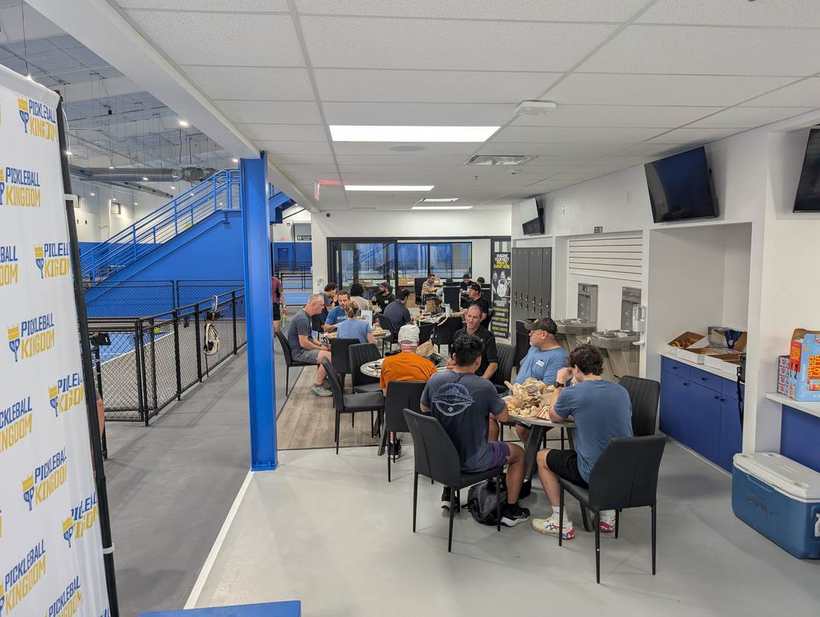 Corporate group enjoying catered lunch at a private event at Pickleball Kingdom