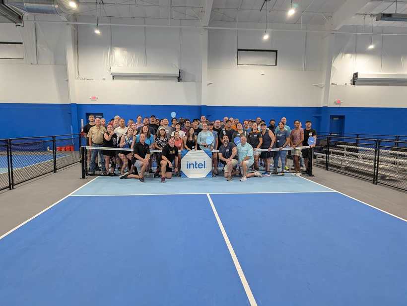 Large corporate group posing on court after a company event at Pickleball Kingdom Pflugerville