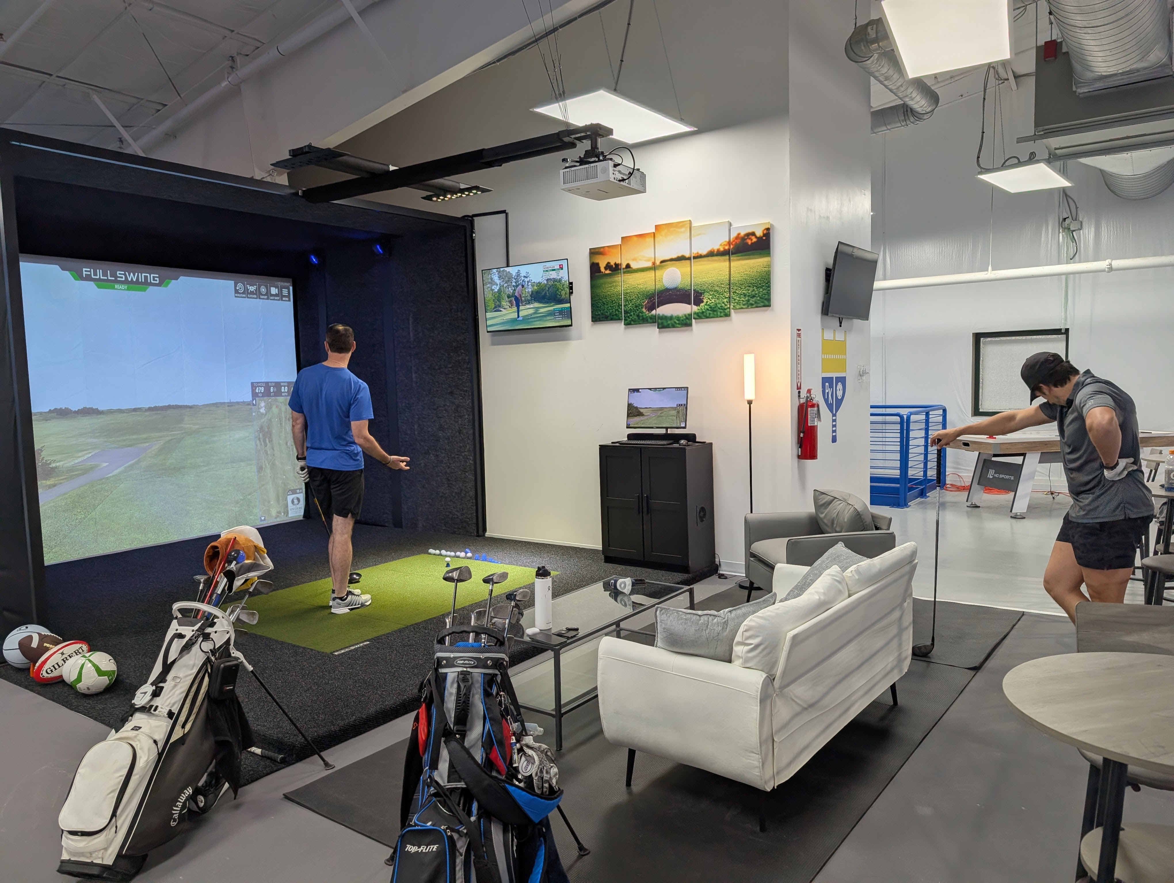 Golfer playing the Full Swing simulator at Austin Indoor Golf inside Pickleball Kingdom Pflugerville