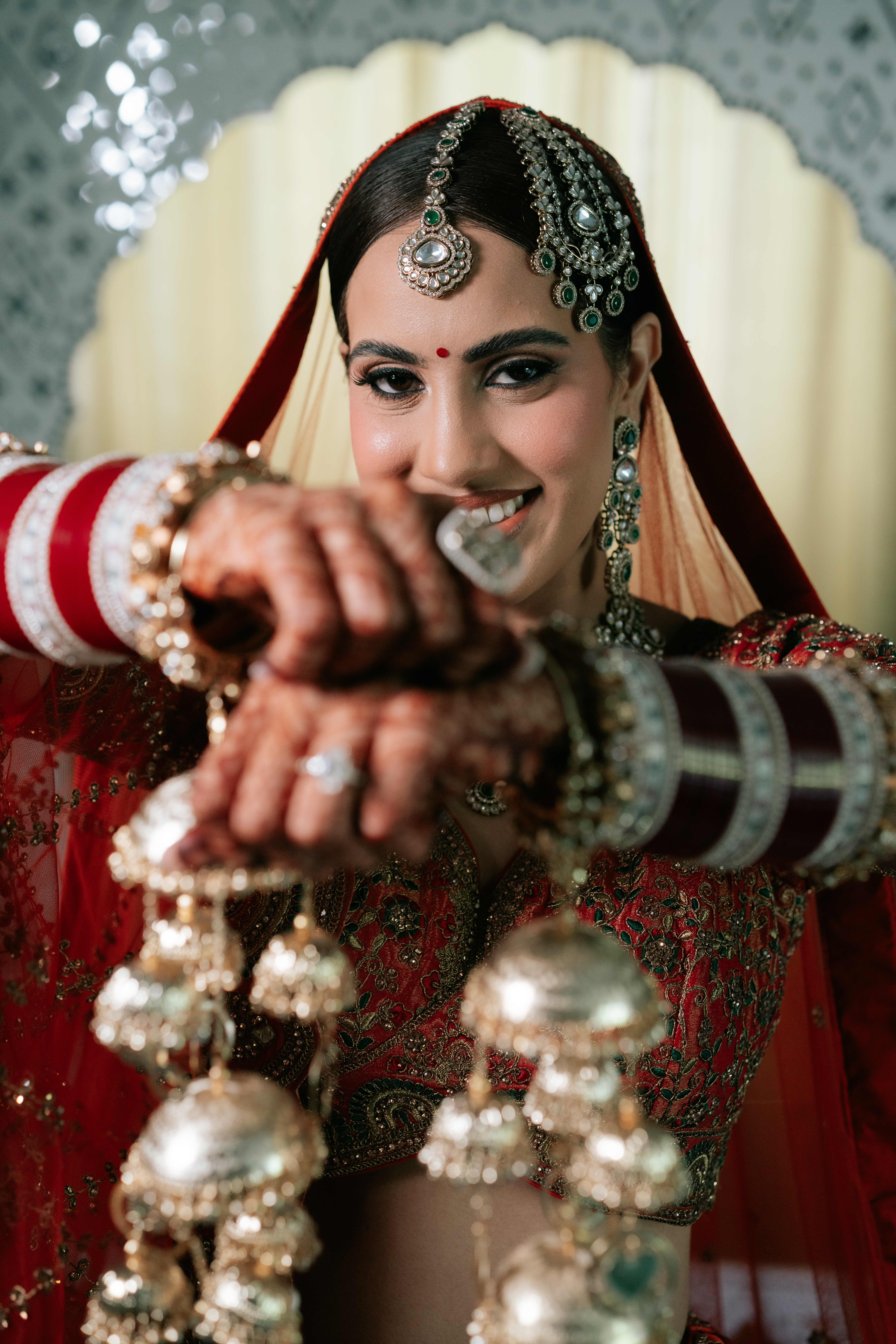 Bride seated by a bookshelf