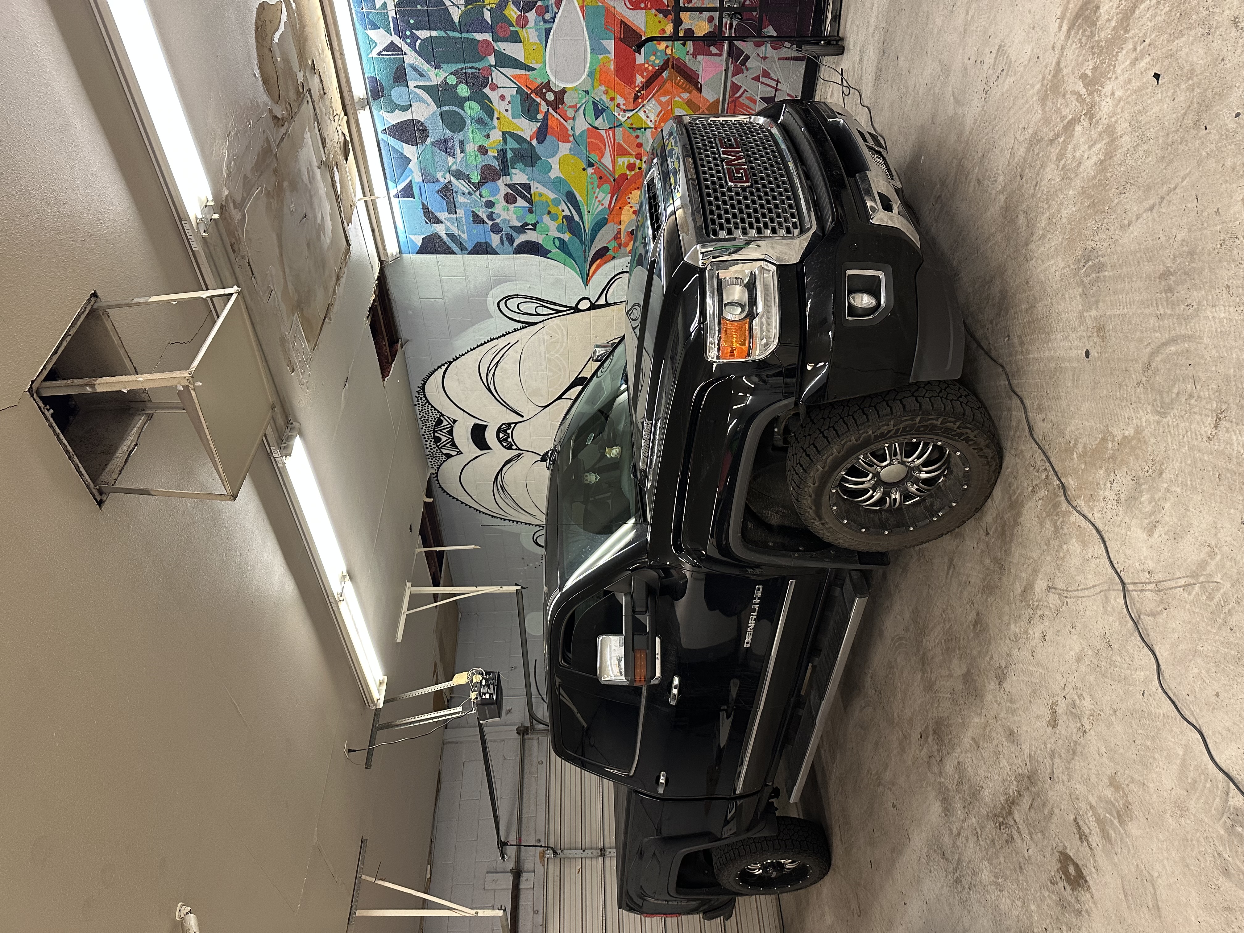 Installer working on black Chevy Silverado ZR2 in Copperstate shop