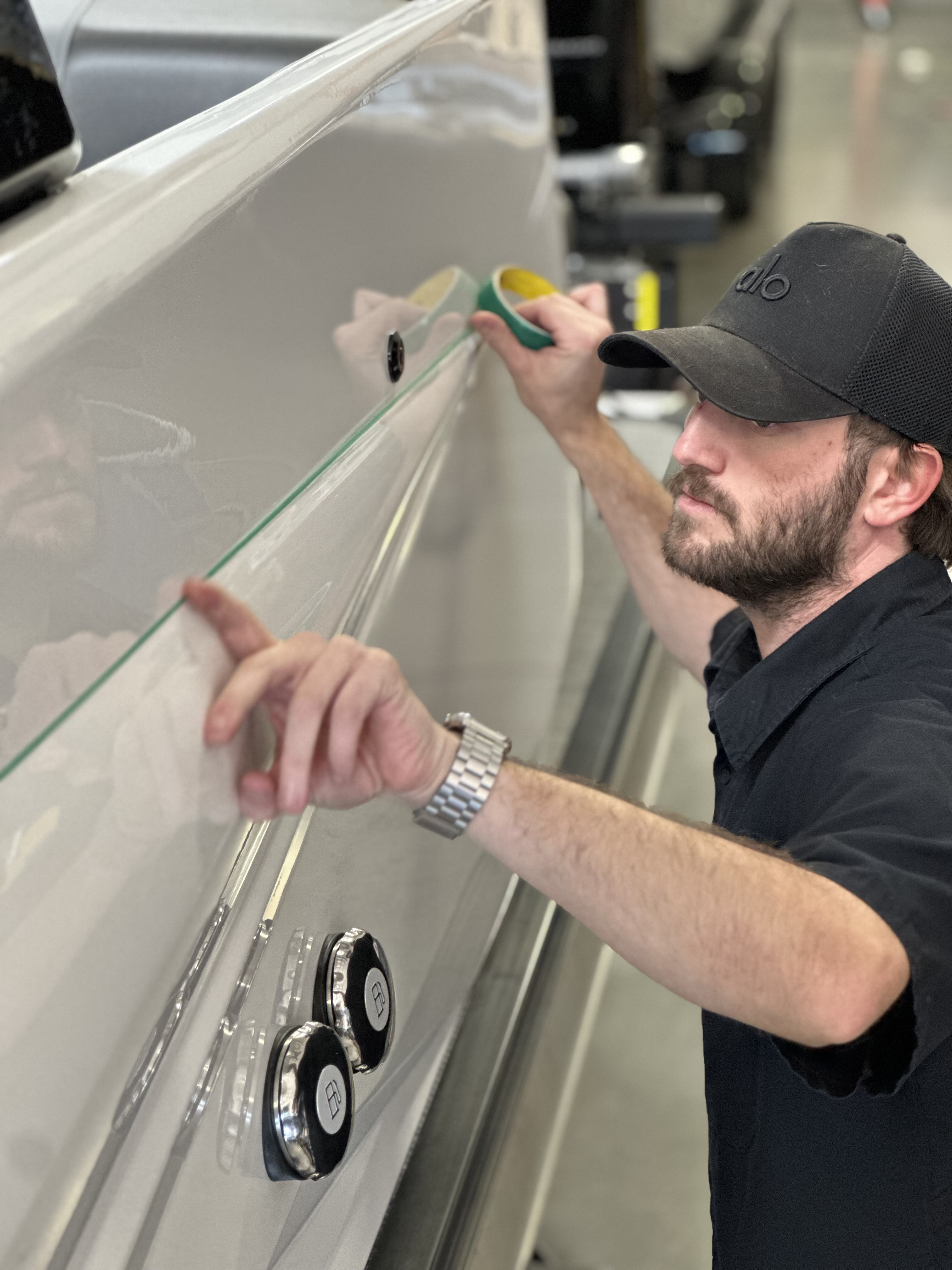 Installer applying PPF to side panel with knifeless tape at Copperstate Tint