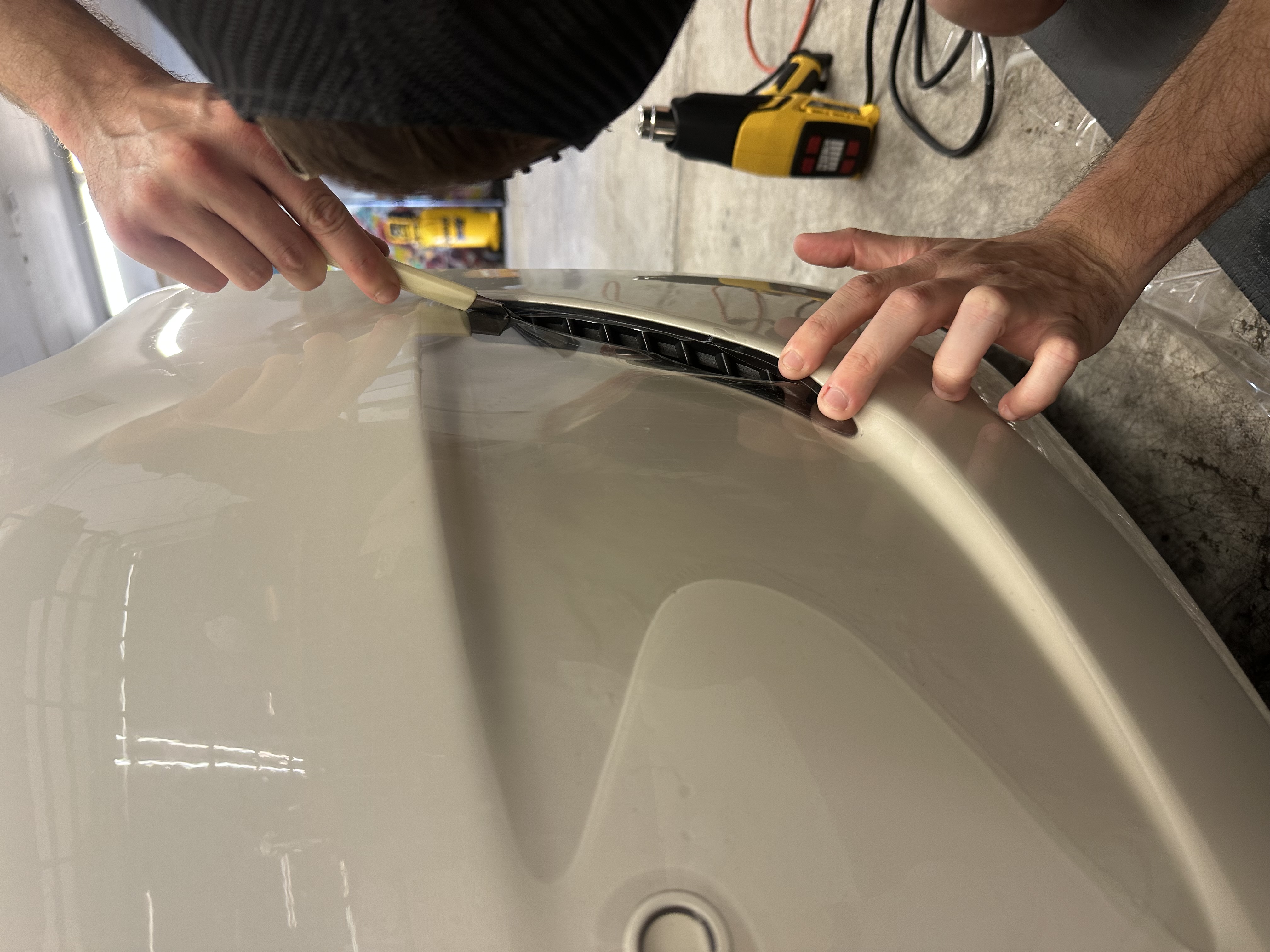 PPF paint protection film install close-up on bumper