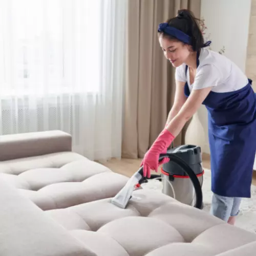 worker cleaning the upholstery