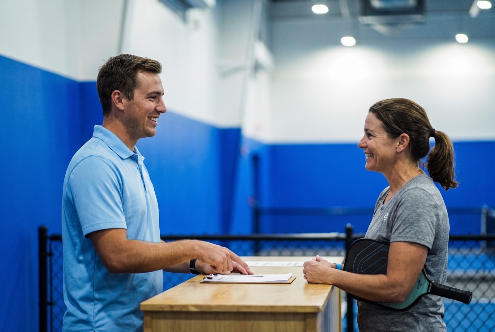 Facility staff warmly greeting a member