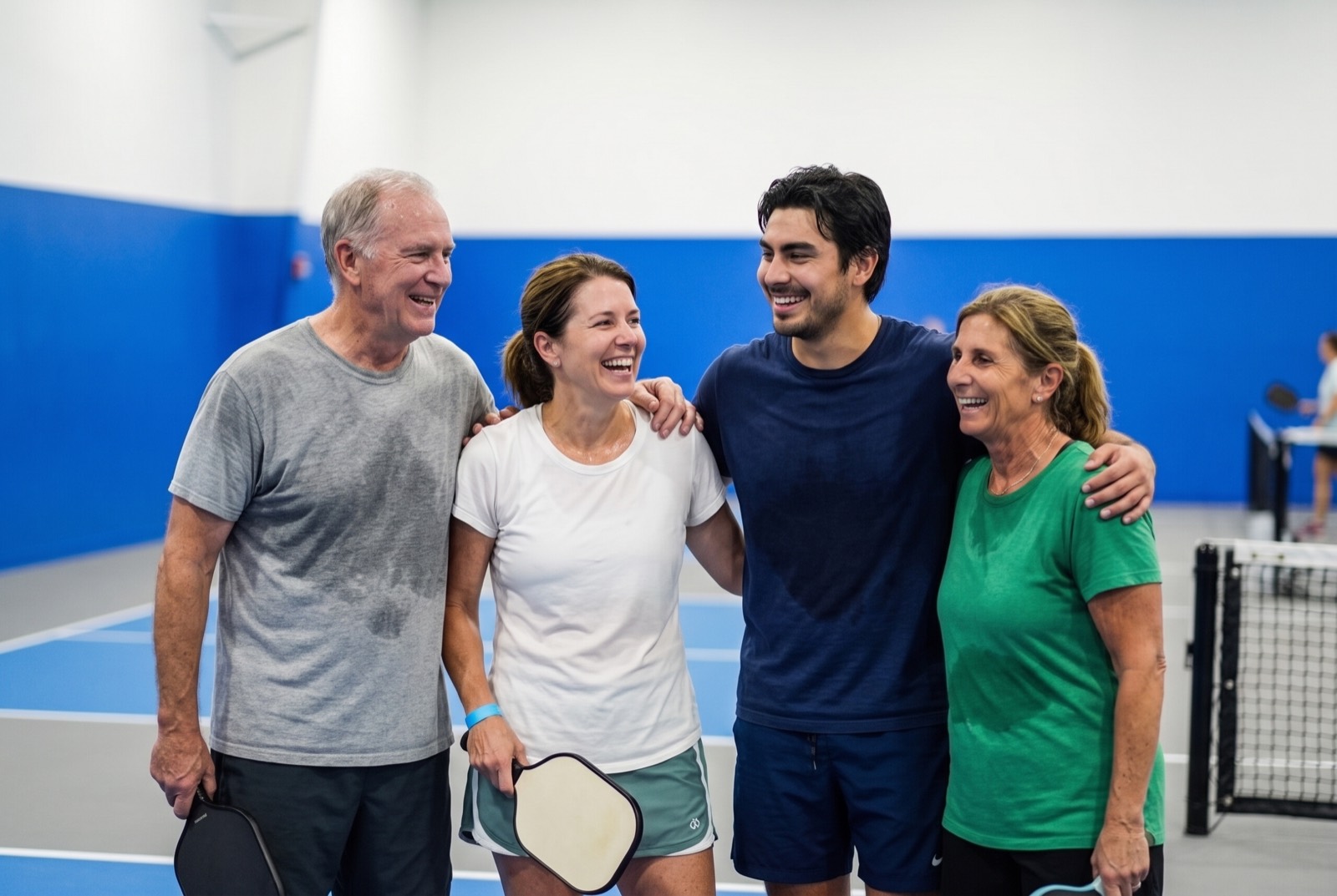 Smiling pickleball members after a game