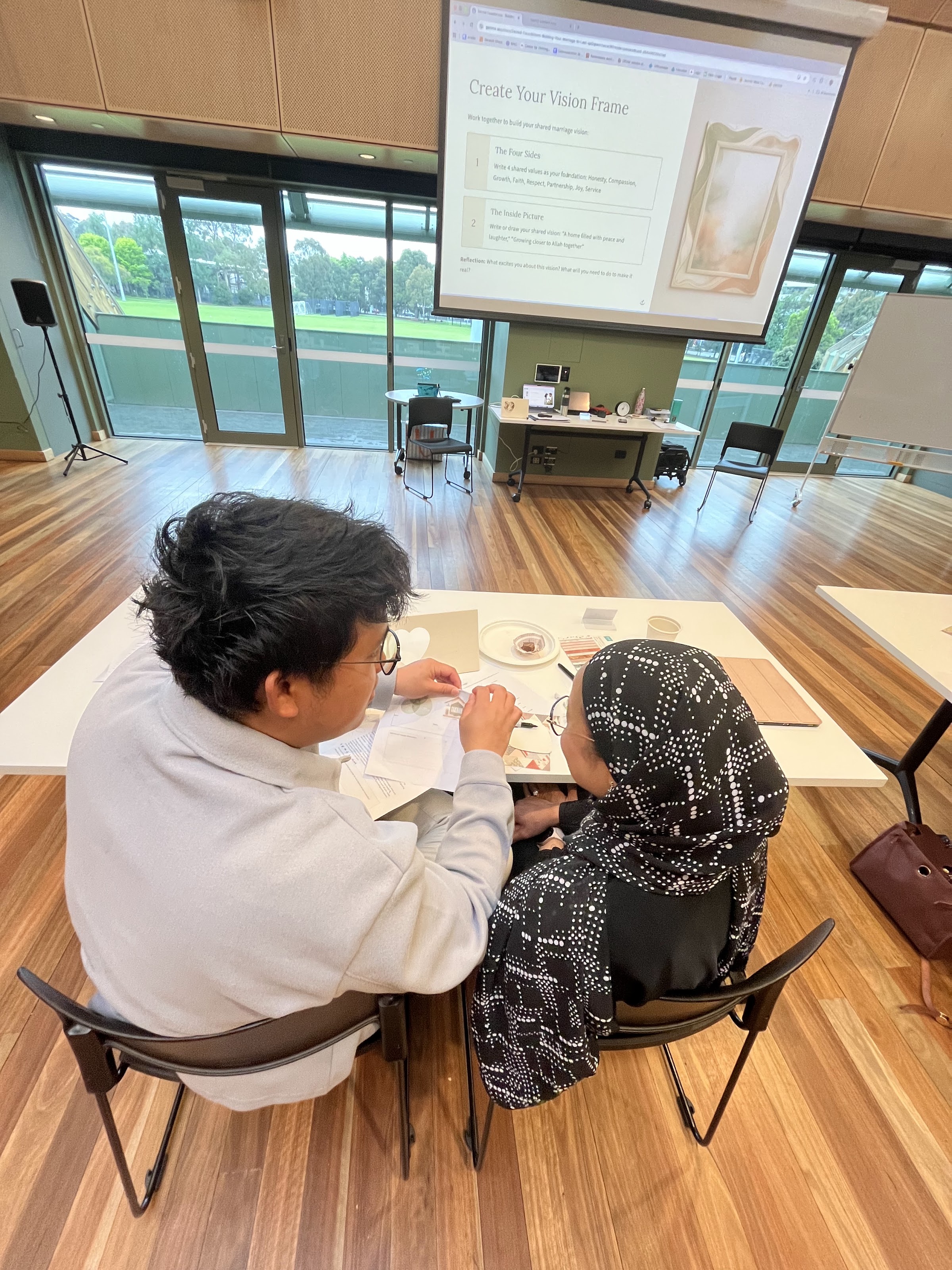 A husband and wife working through their sheet together at their table