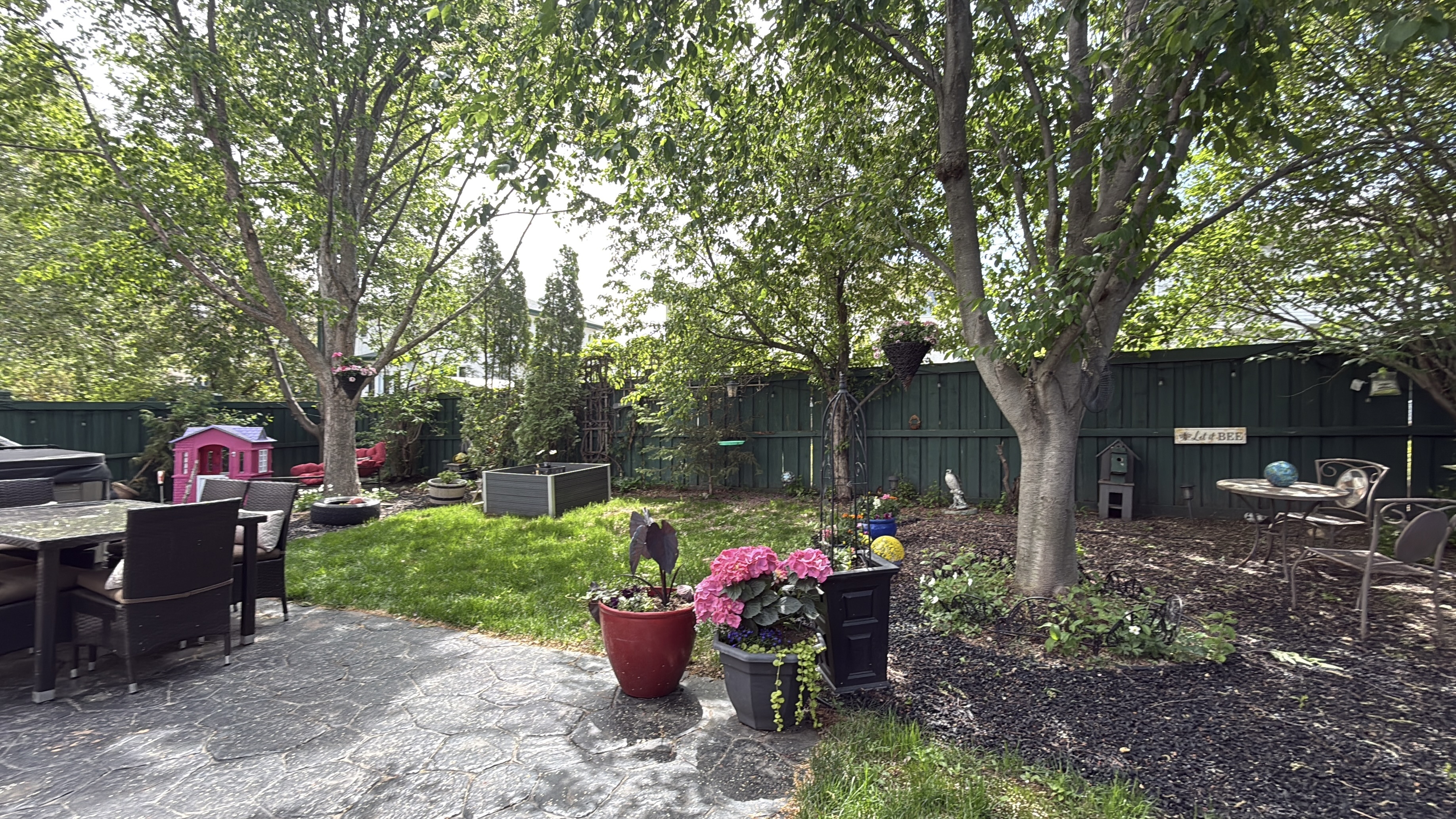 A landscaped backyard patio and garden at an Edmonton family home.