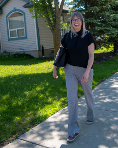 Cathy Cookson, Edmonton realtor, smiling as she walks through a residential neighbourhood on a summer day.