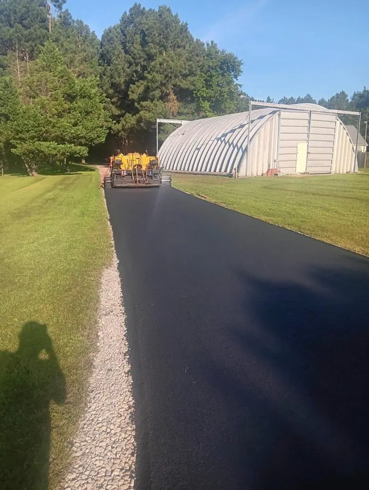 Paving roller compacting a newly laid asphalt surface