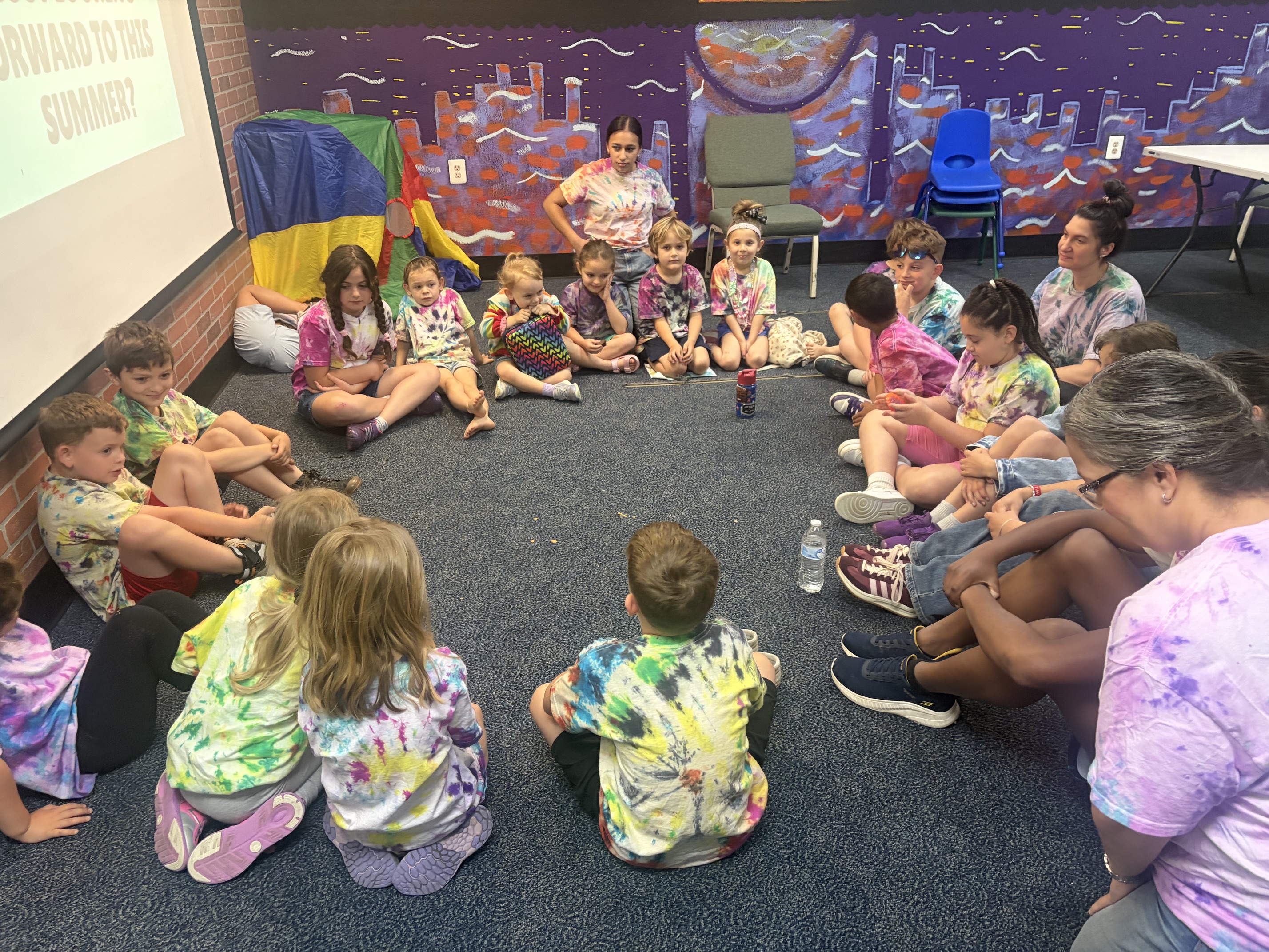 Radiant Pathways students and teachers sitting together in a circle during a class activity