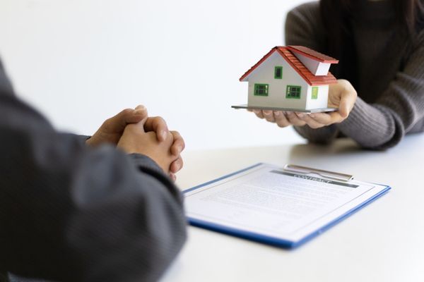 House keys being handed from one person to another