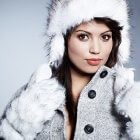 Woman wearing a white fur hat and a grey coat with white fur trim