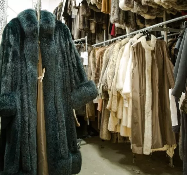 Rack of fur coats in Toronto including a long dark teal fur coat
