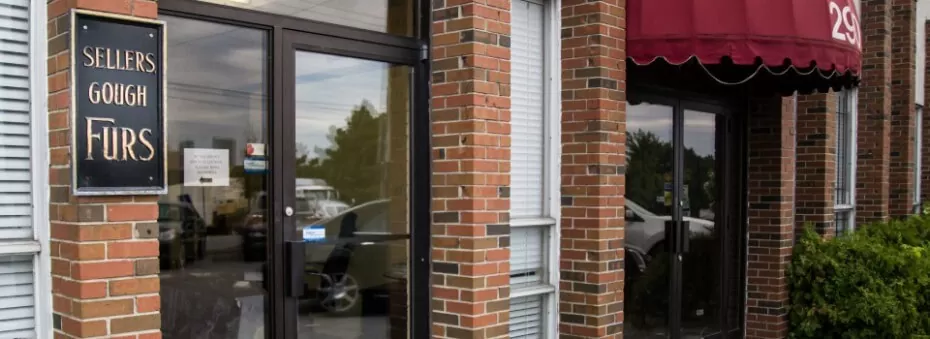 Brick storefront entrance with a red awning