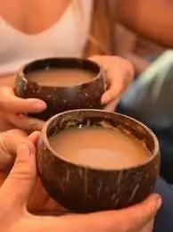 Two people drinking kava