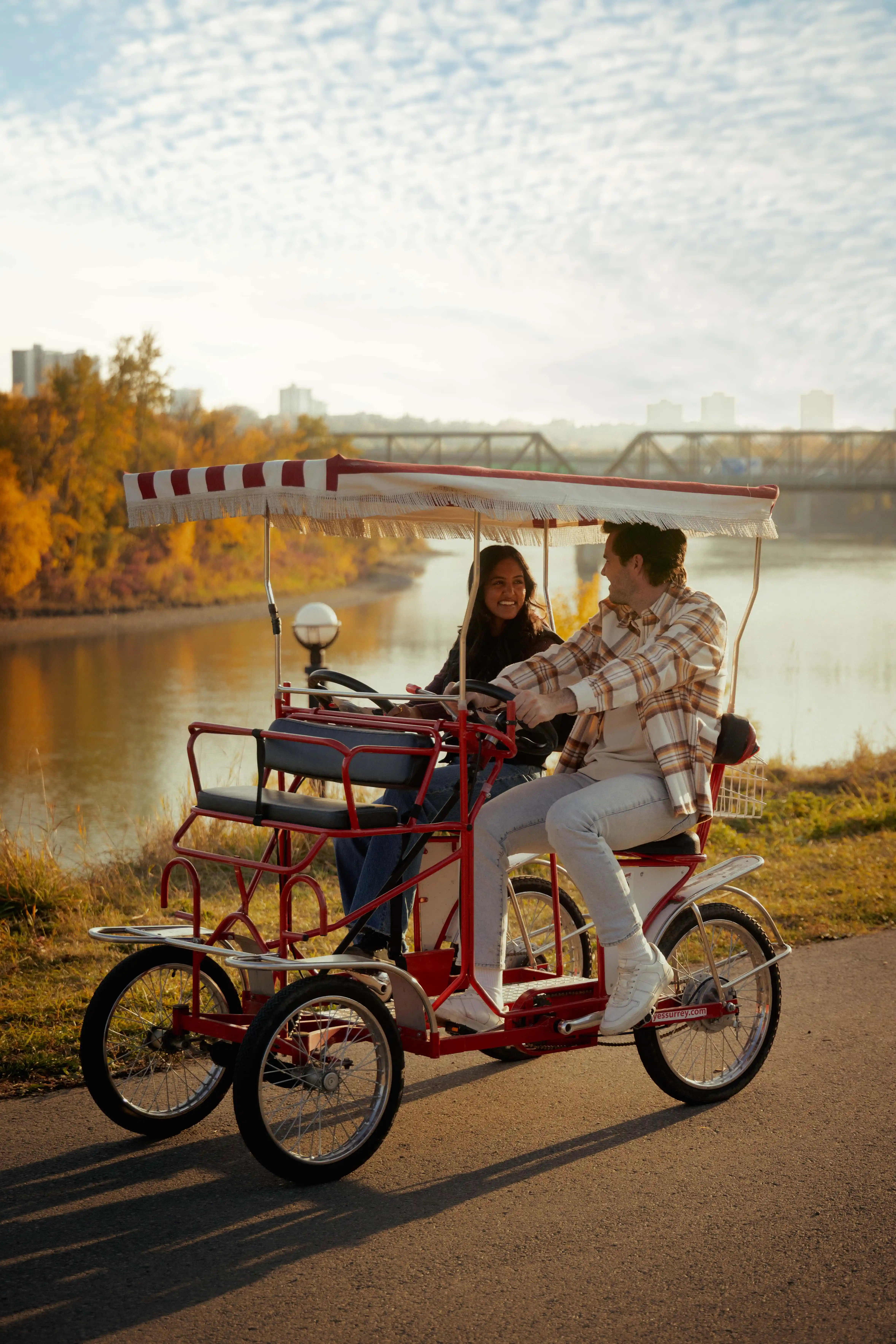 Friends riding bikes on a bridge in Edmonton River Valley