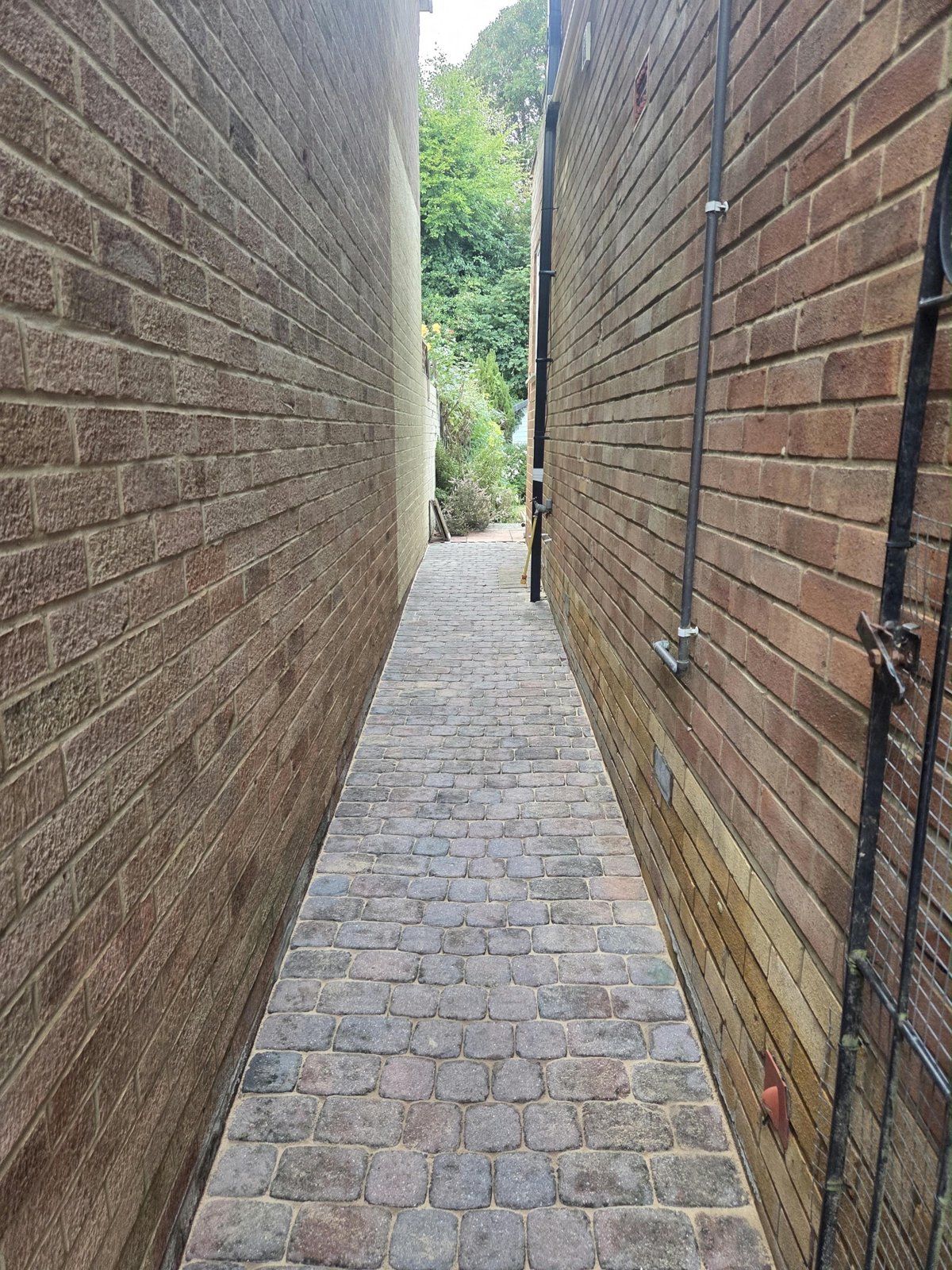 Block paving side alley with clean blocks and freshly sanded joints