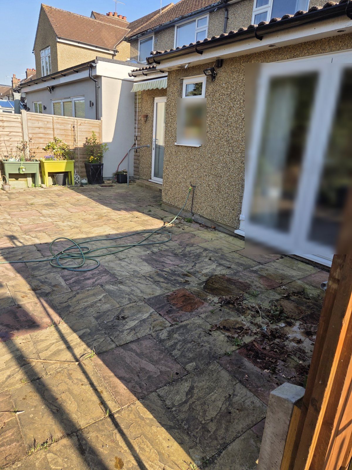 Before: algae-stained slabs with weeds and leaves along an extension