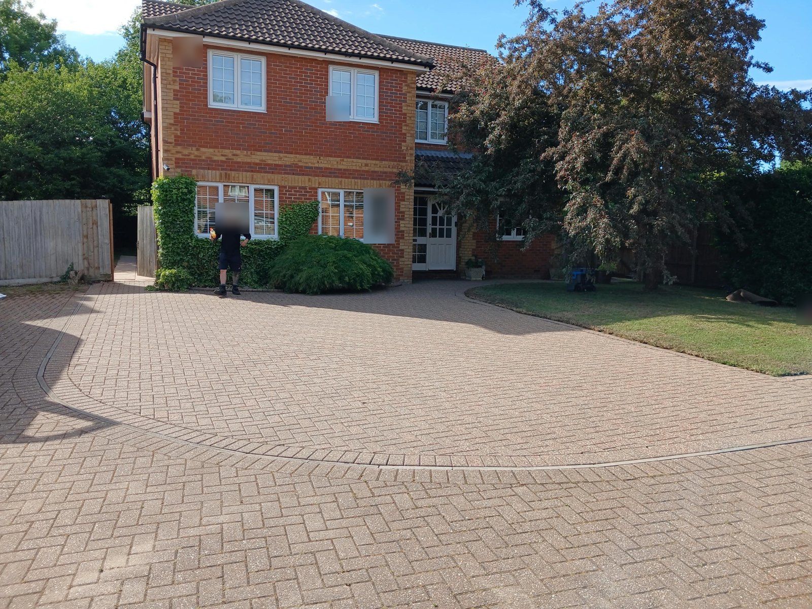 The same herringbone driveway cleaned to an even, lighter buff