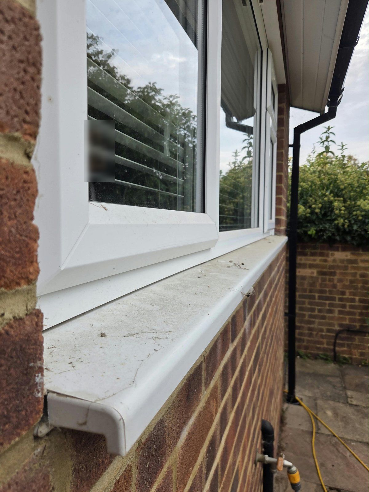 Before: grimy white window sill