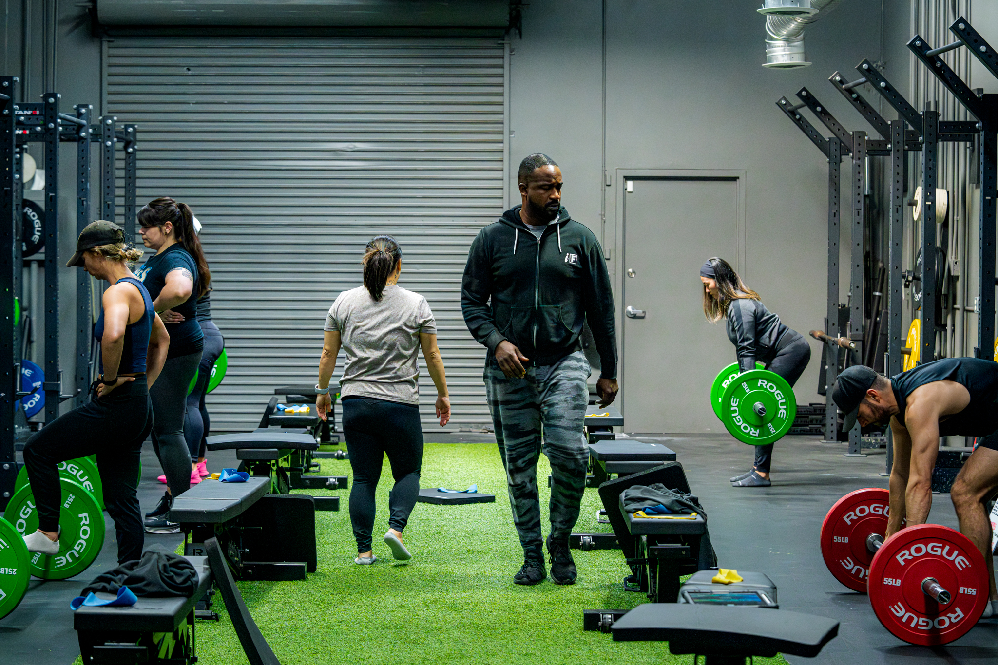 Coach in group training showing a structured workout Coach in group training showing a structured workout