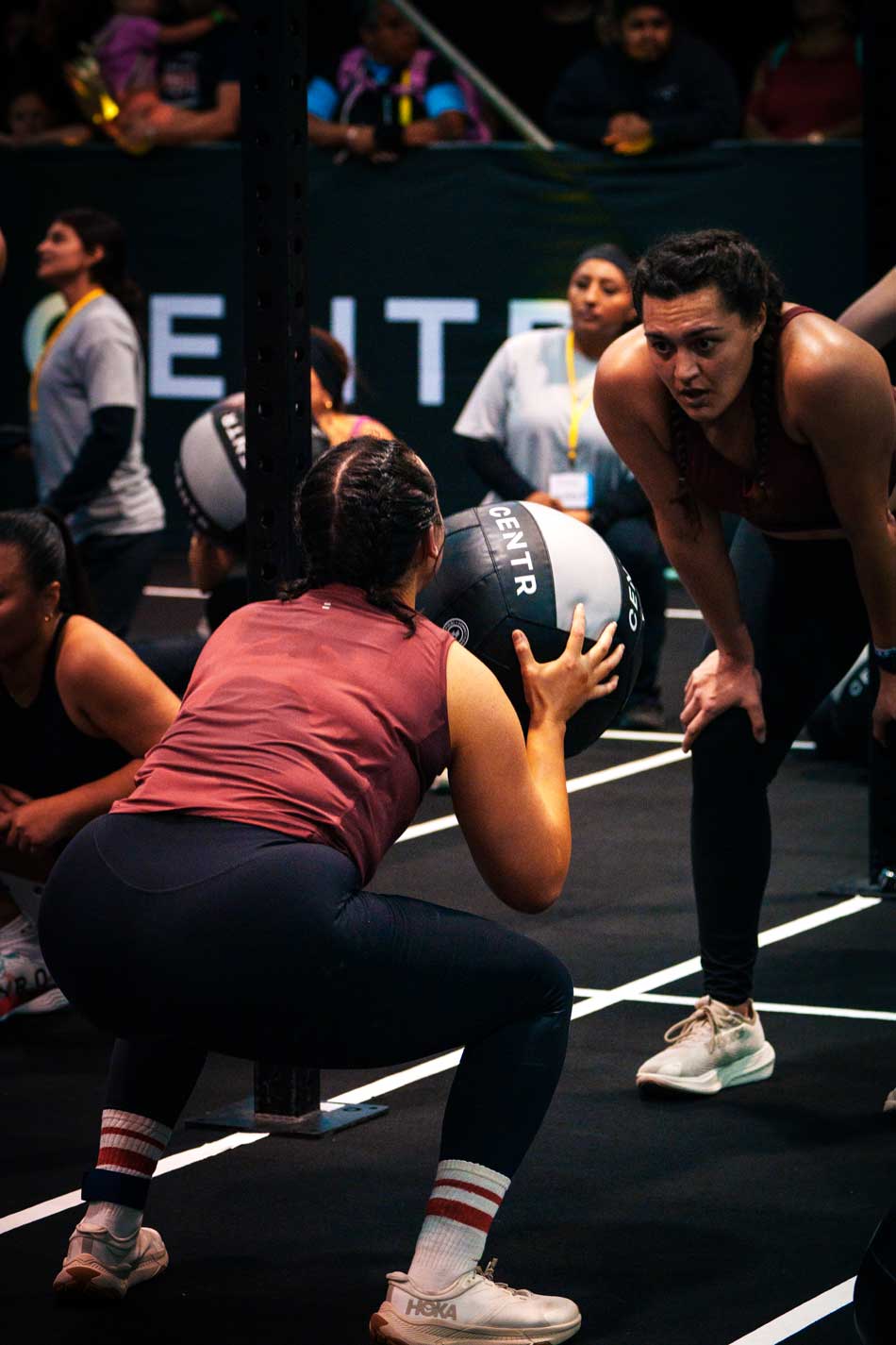 Hyrox event with athlete doing wall balls Hyrox event with athlete doing wall balls