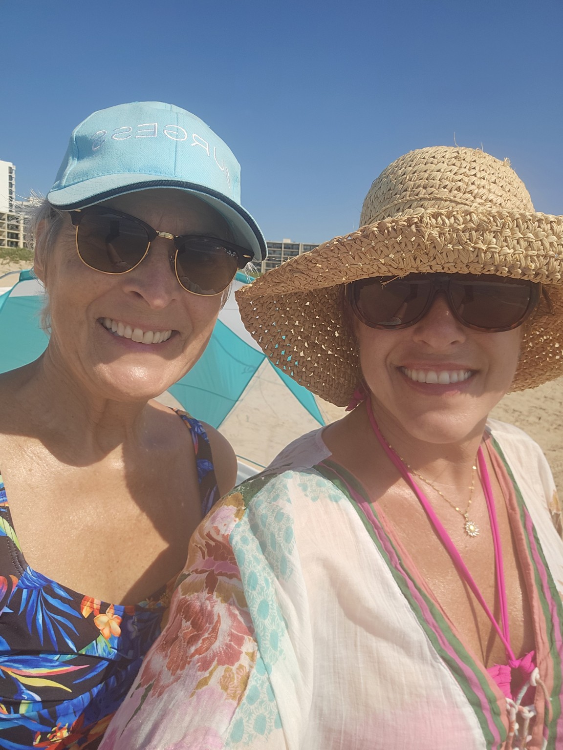 Tara and her mom enjoying a sunny day on the beach in Padre Island, Texas.