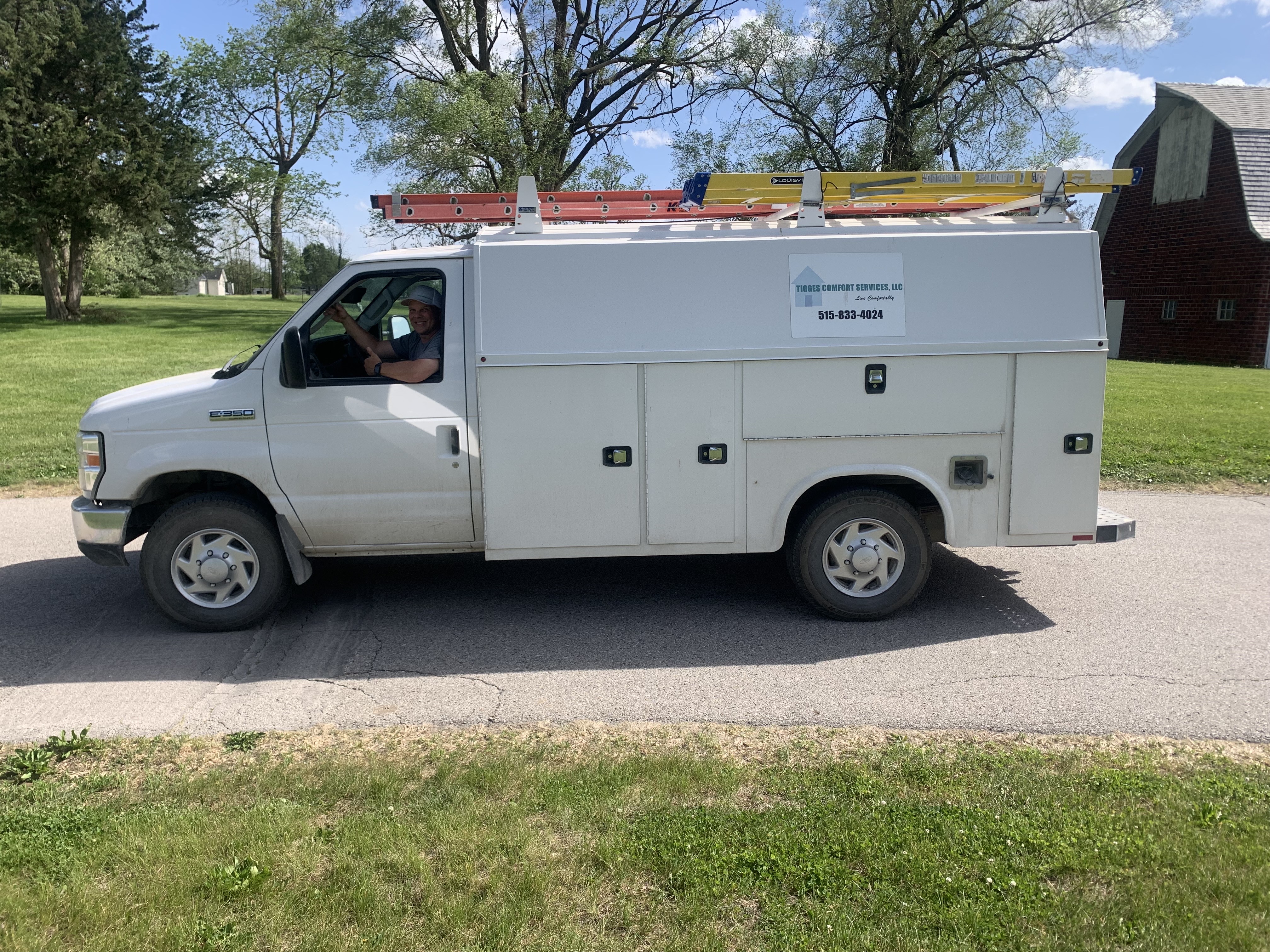 Jason in one of the Tigges Comfort Services work trucks near Redfield, IA