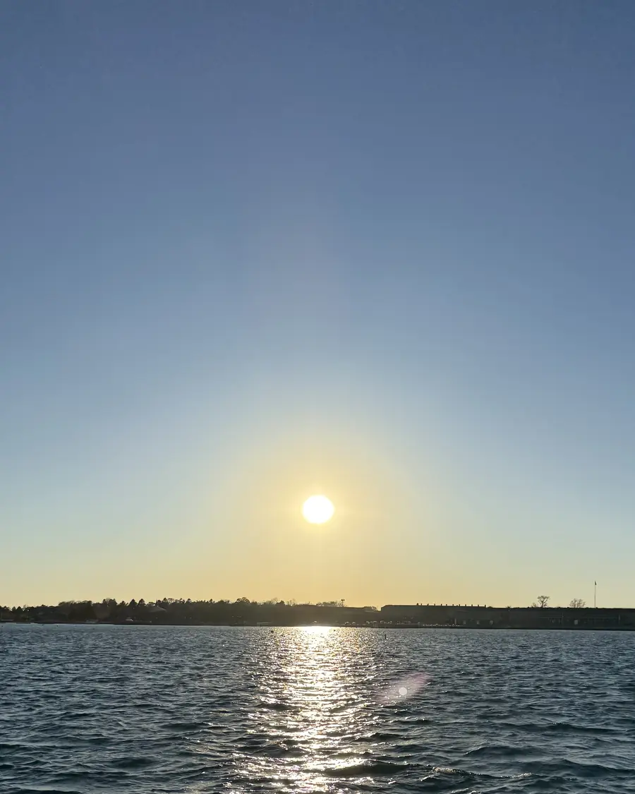 Sun setting over open water