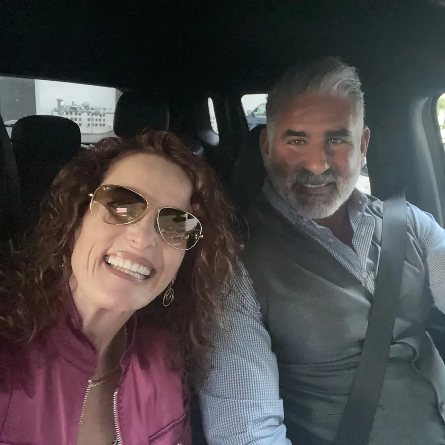 Tanya and her husband Vince smiling together in the car